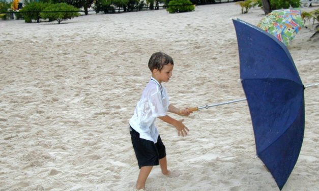 Boy Learning to Use Umbrella